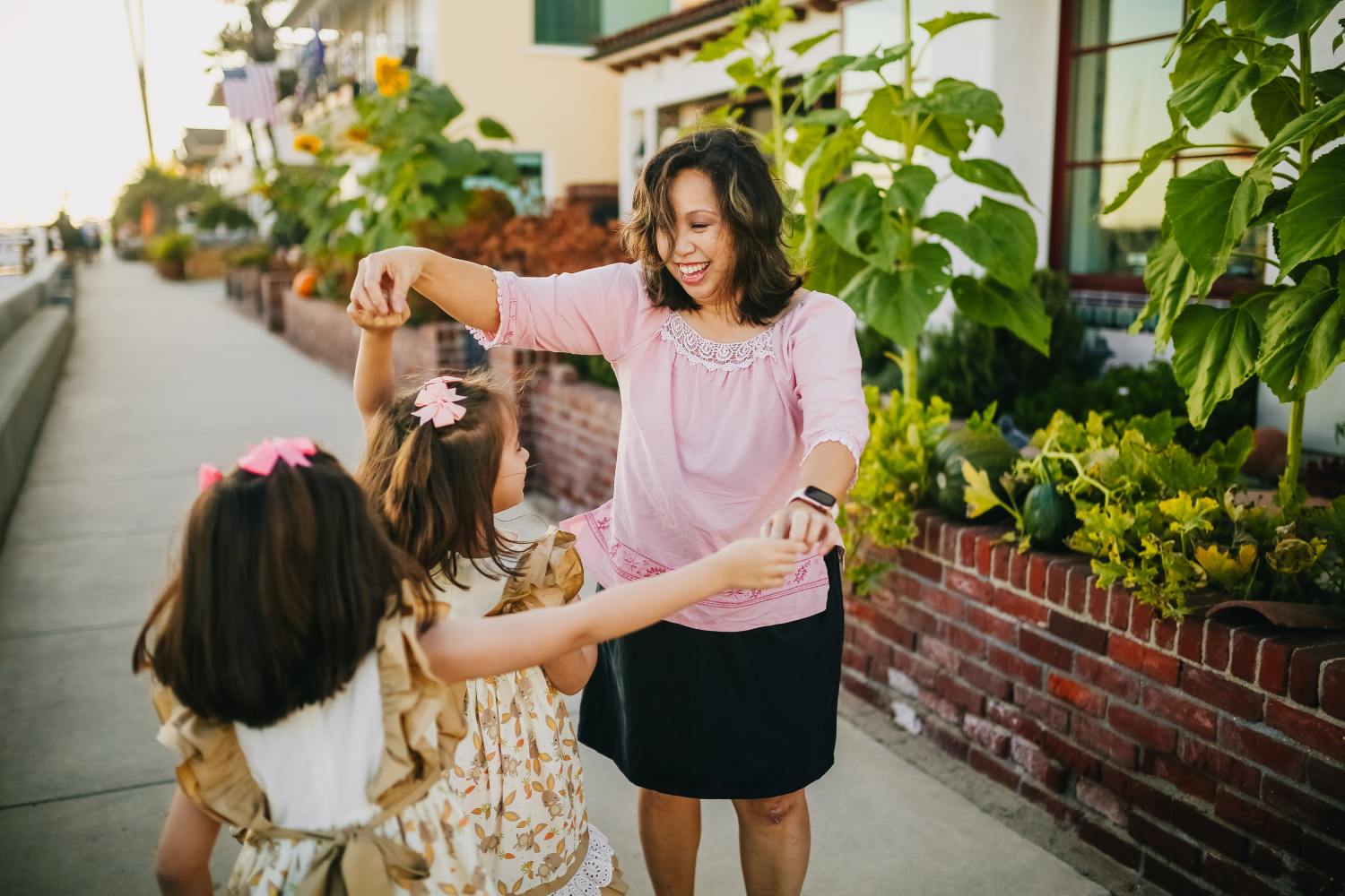 Mother who built first generational wealth dancing with daughters.