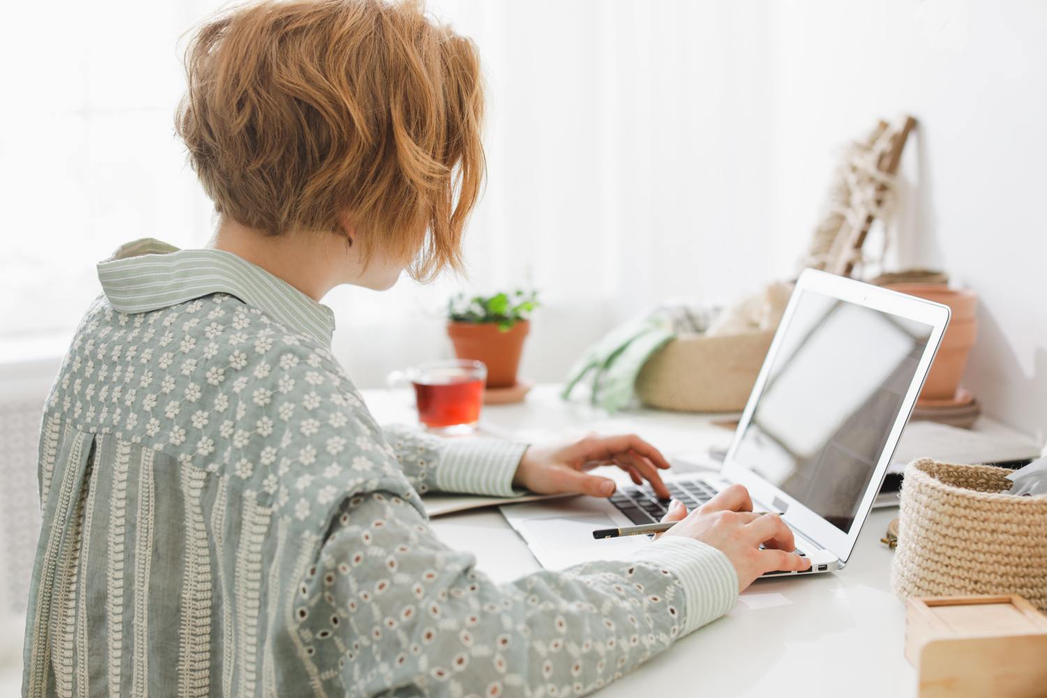 Woman researching on computer if you can remove someone from a deed.