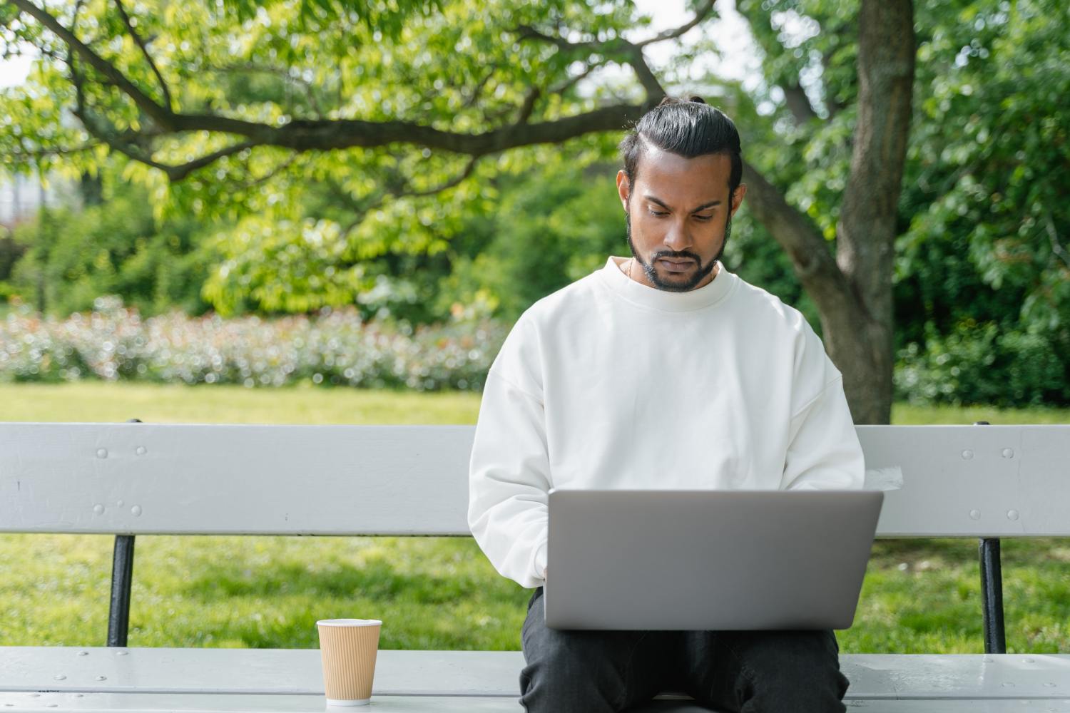 Man on laptop looking up the difference between deed and mortgage.