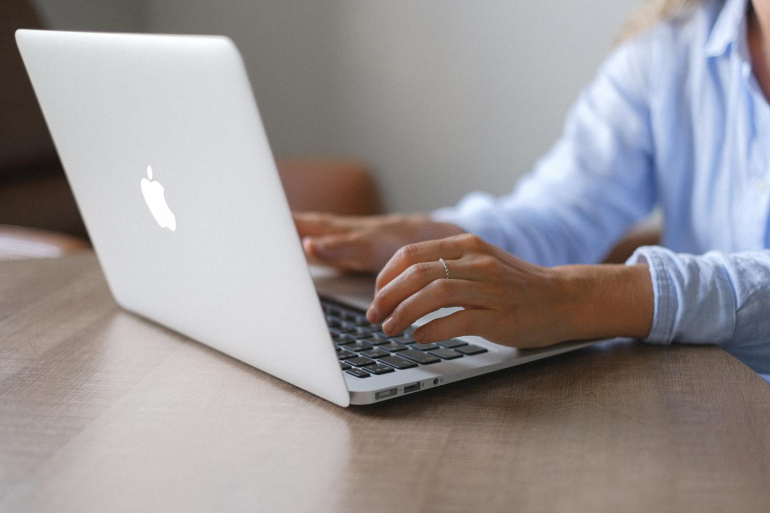 Person on laptop researching how to recover escheated funds in California.