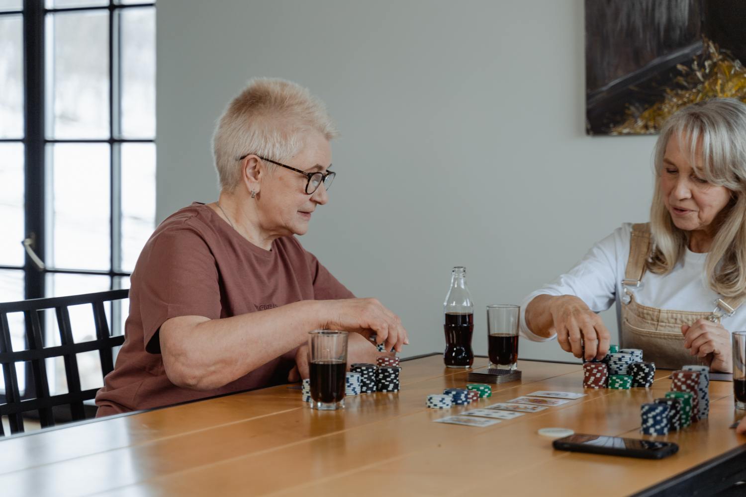 Two women playing a game after learning about the escheatment process.