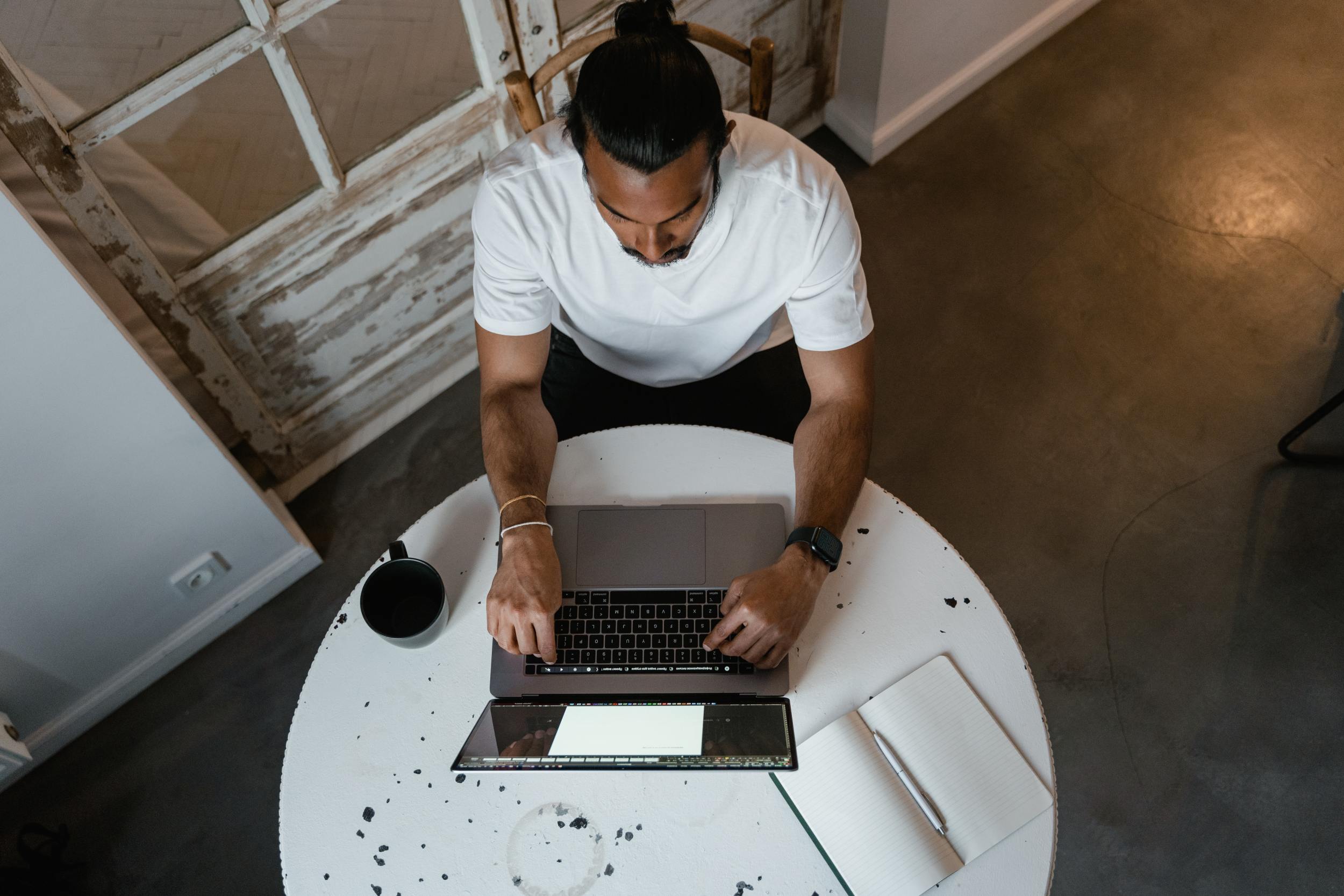 Man on computer researching financial security through estate planning as an employee benefit.