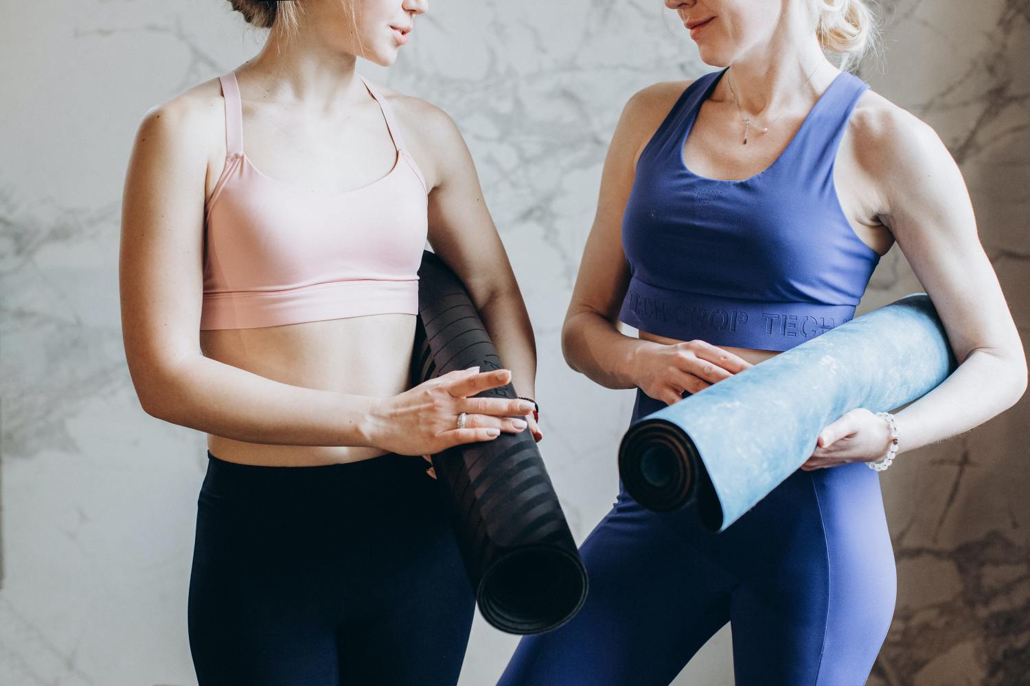 Women holding yoga mats after creating generational health for their family.