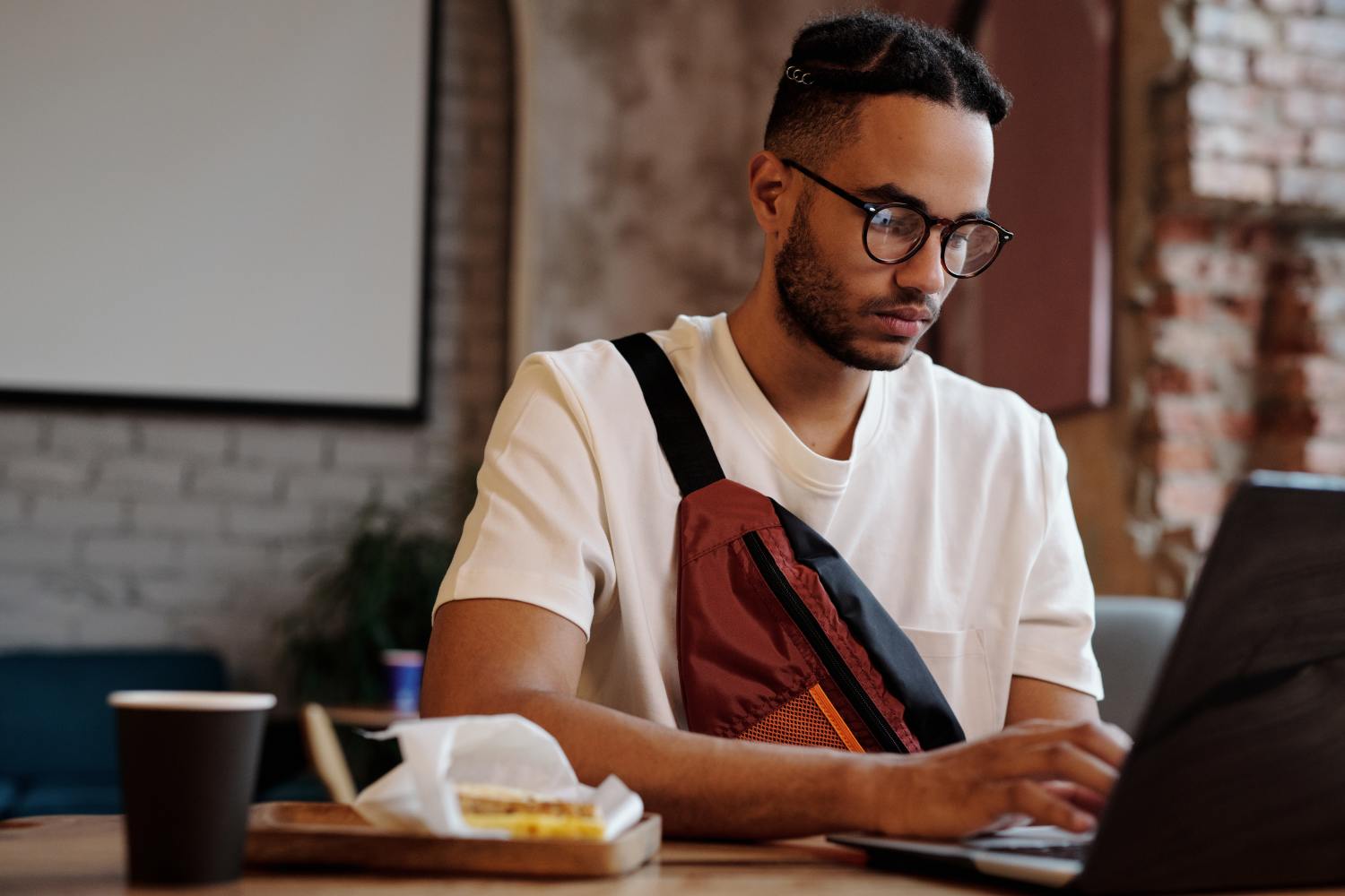 Man on laptop researching how to find a life insurance policy.