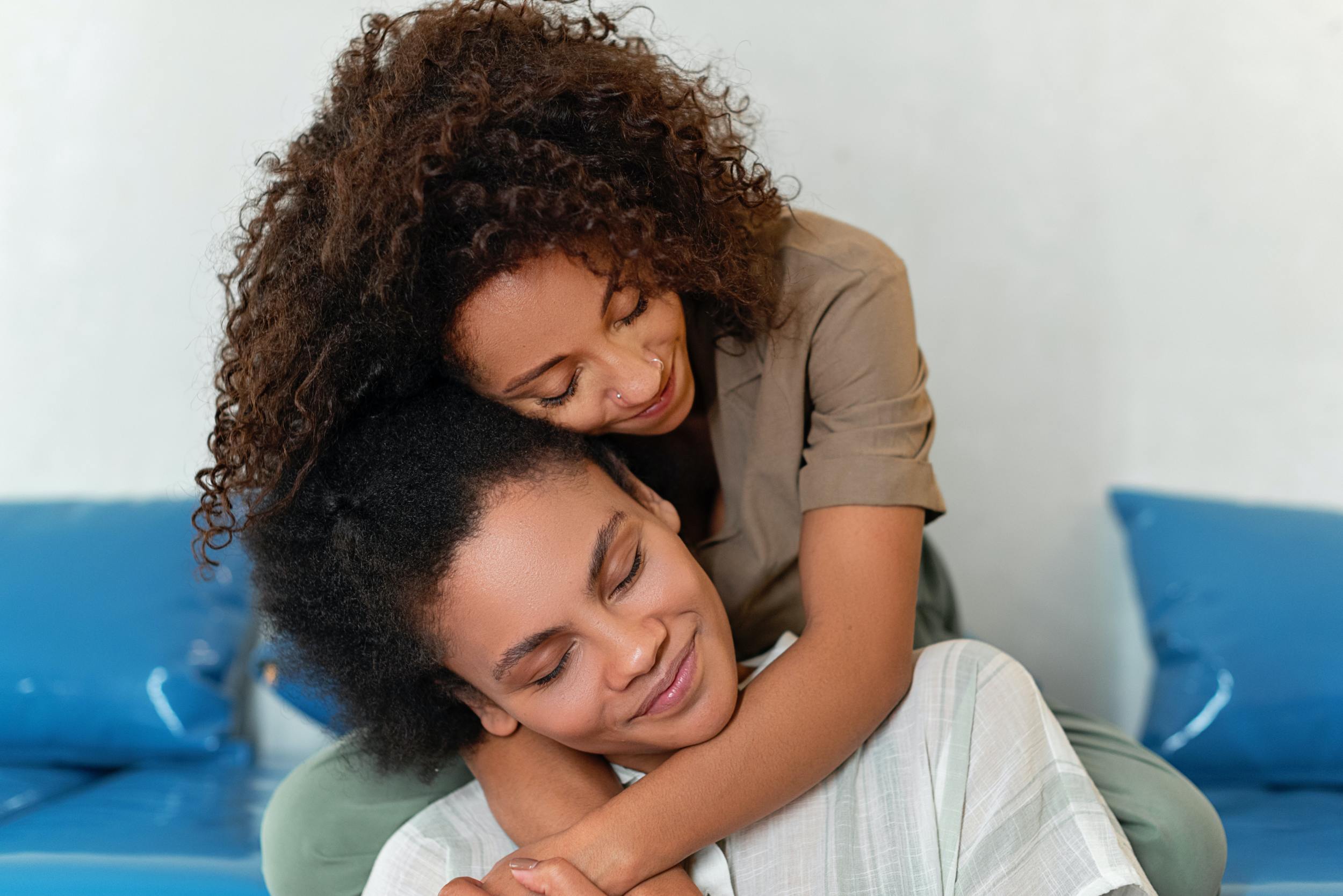 LGBTQIA couple hugging after completing their estate planning as en employer benefit.