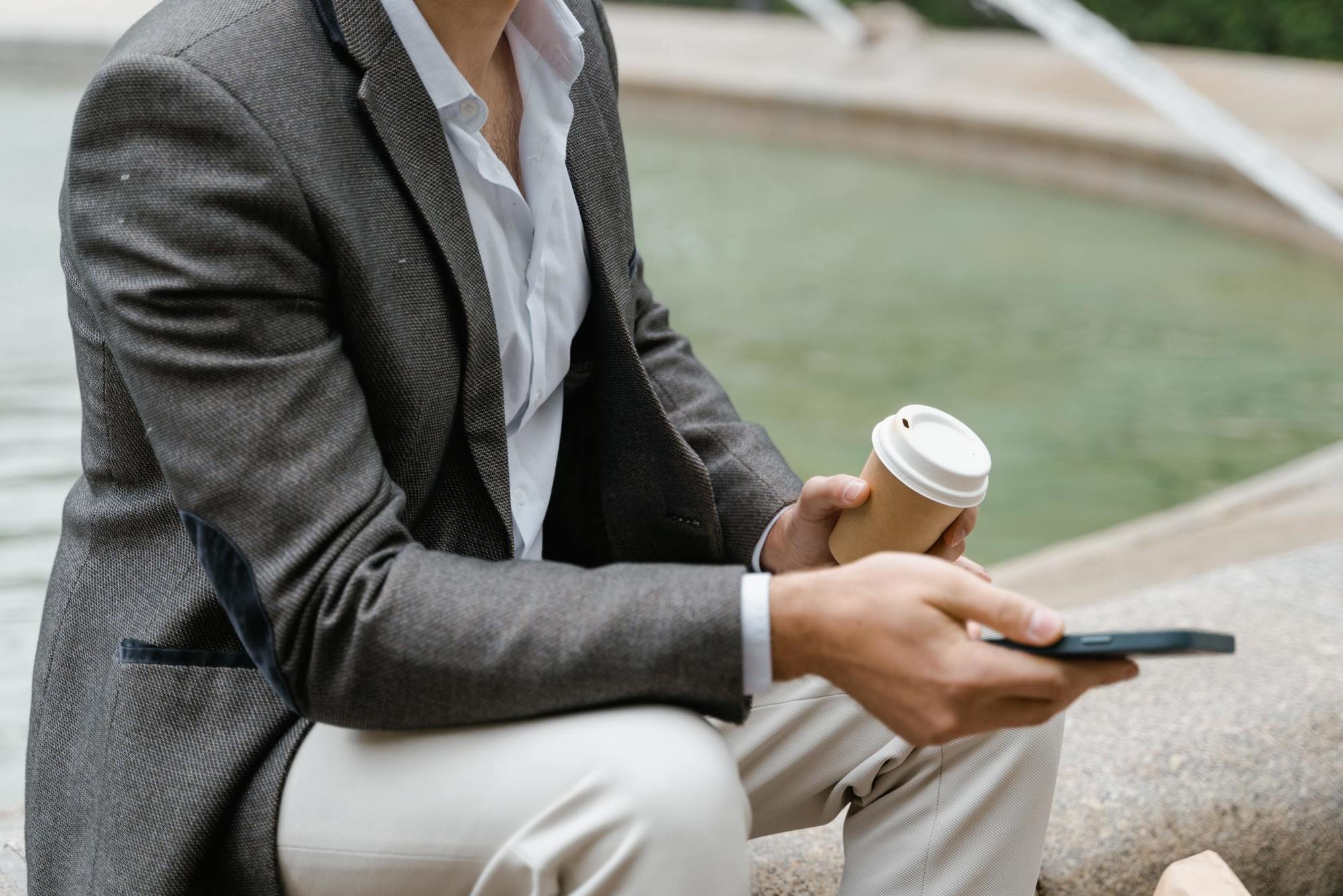 Man on phone looking up 401k changes happening in 2023.