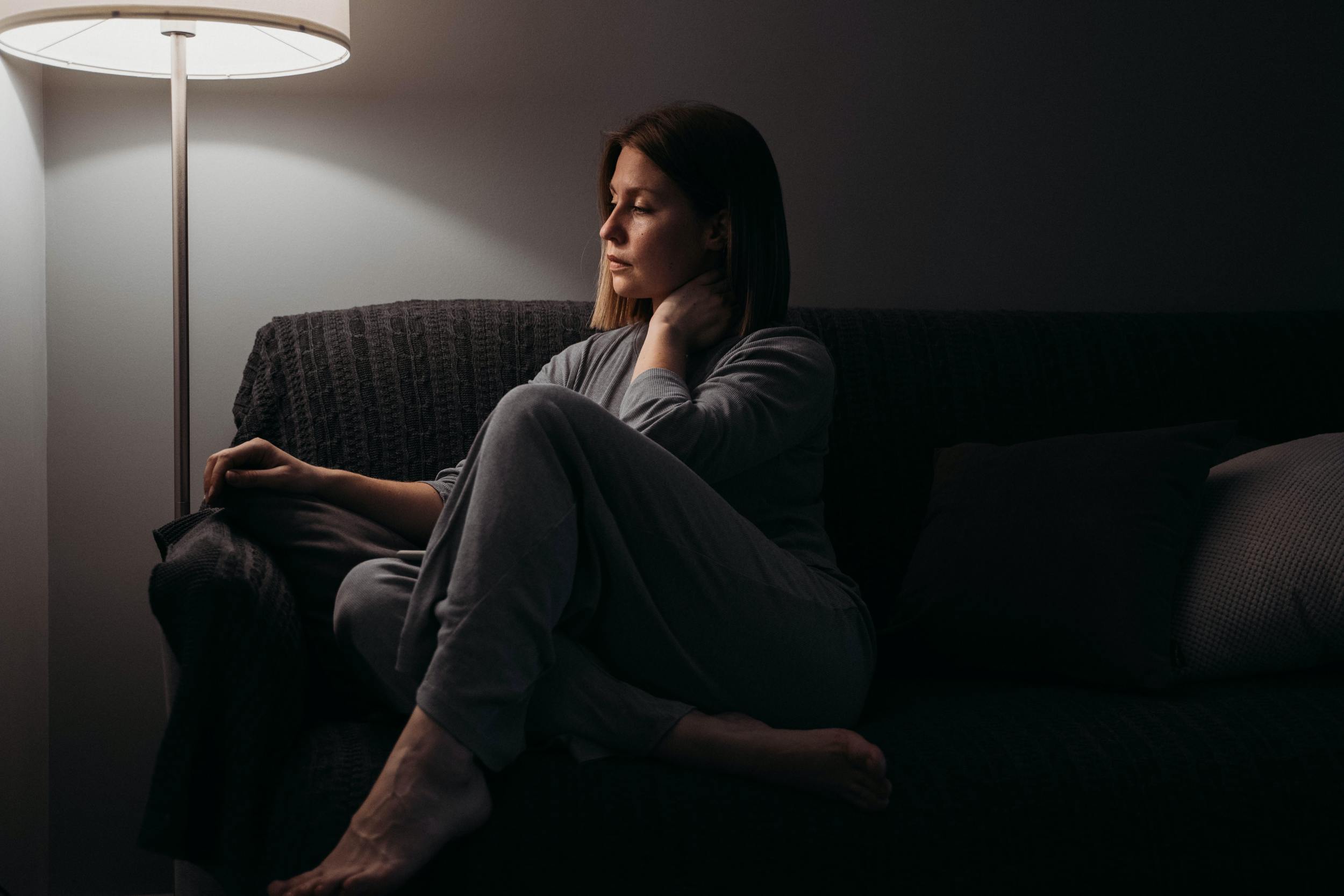 Woman grieving after taking time off for bereavement care as an employee benefit. 