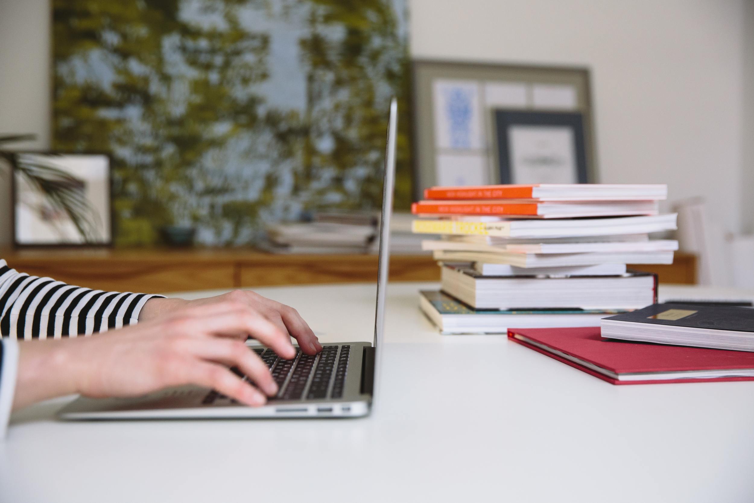 Someone on laptop looking up the most helpful Trust & Will articles of 2022.