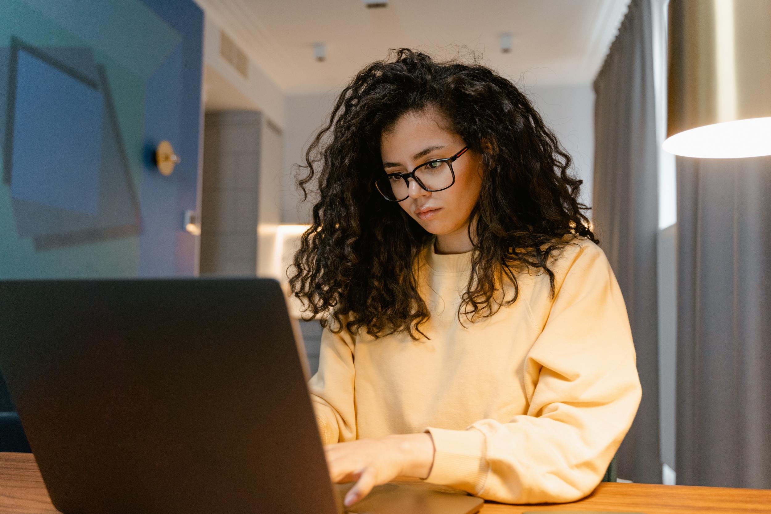 Woman on laptop researching the difference between wills, trusts, and prenups.