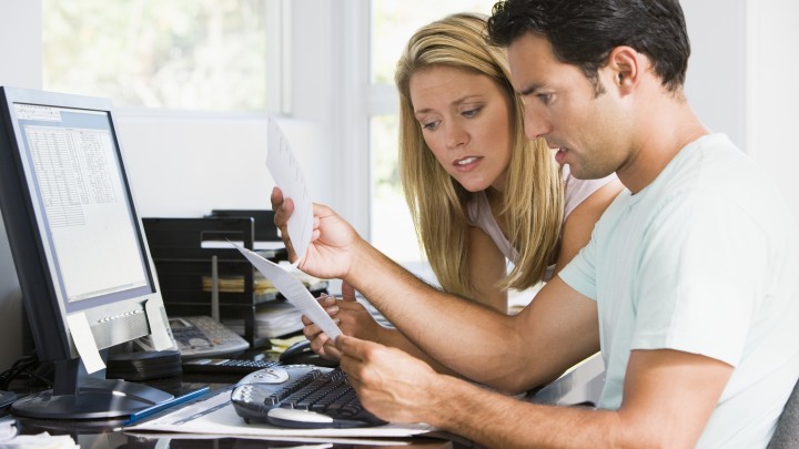 Couple looking through forms trying to figure out California probate bond guidelines.