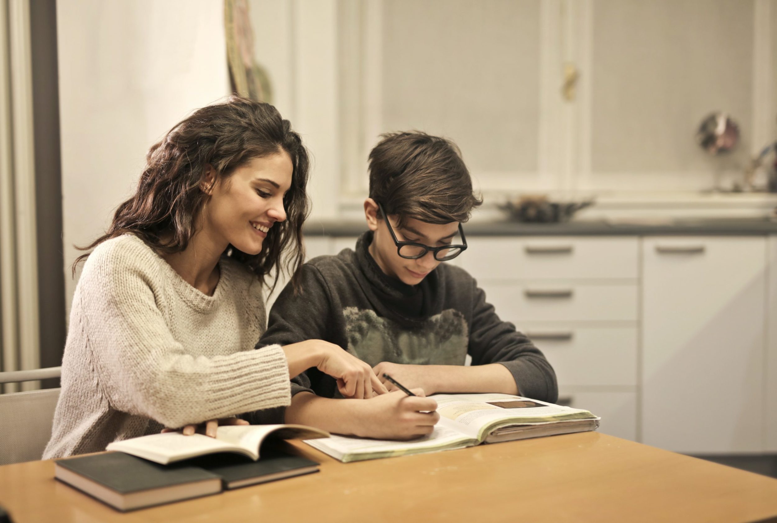 mother helping son with homework