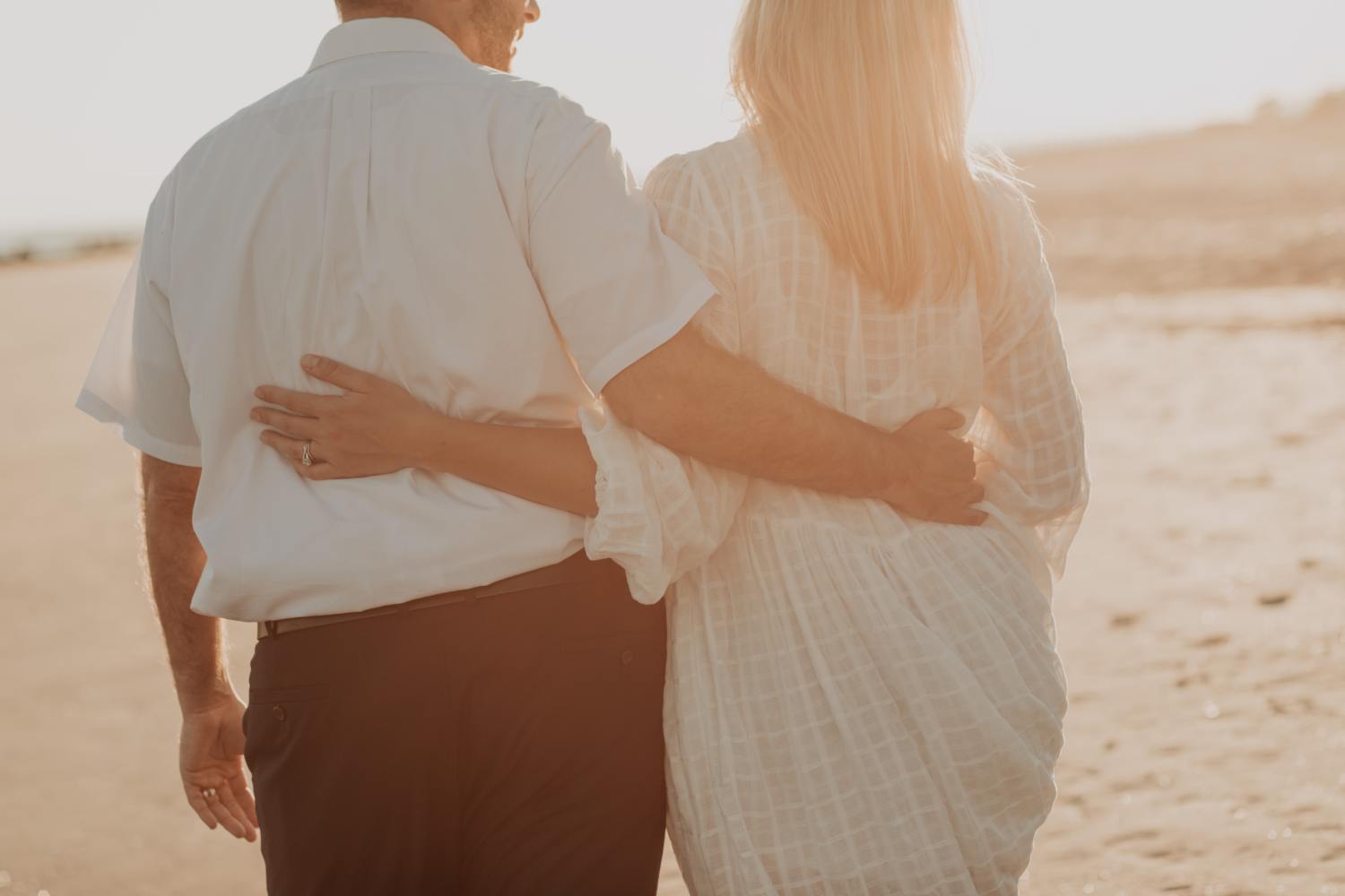 Married couple on the beach talking about spousal property petition vs probate.