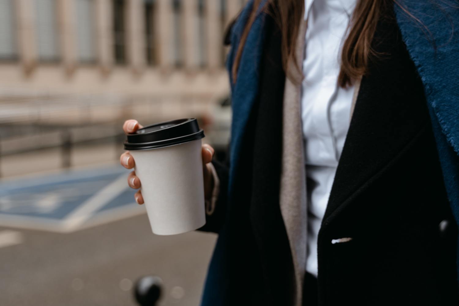 Woman holding a coffee cup after losing the lottery.